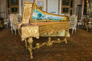 ISOLA BELLA, ITALY - JUNE 2, 2018: Photo of beautiful old harpsichord in the Borromean Palace, Isola Bella, Italy. Isola Bellas palazzo is like a baroque chest of wonders floating on the water. clipart