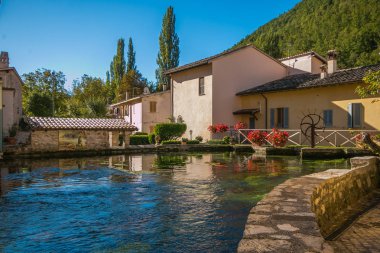 RASIGLIA, ITALY - OCTOBER 5, 2019: The village of Rasiglia is a charming place, where you will rediscover the forgotten atmosphere of the little ancient things. clipart