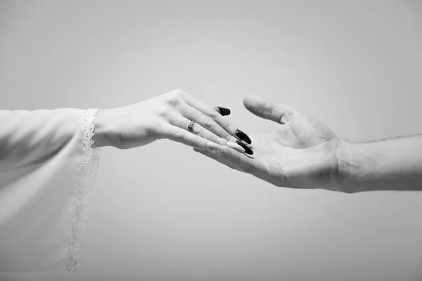 Hands Man Woman Reaching Each Other Gray Background Black White — Stock Photo, Image
