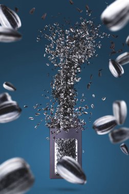 Kuru Ayçiçeği tohumları Paketi'ndeki dışarı sinek ve havada donmuş mavi arka plan üzerinde duruldu. Studio fotoğraf çekim. Poster kavram tanıtımı