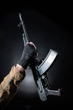 Maske ve koyu arka plan makinalı tüfek ile tehlikeli silahlı terör. Terör ve şiddet kavramı.