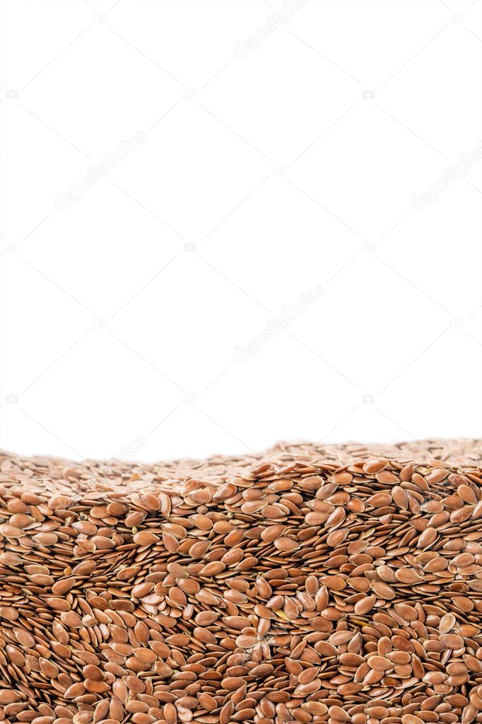 Layer of flax seeds in section isolated on white background. Agriculture poster concept