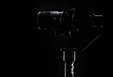 Siyah arka planda Steadicam ve kamera. Kameraman için ekipman. Pürüzsüz ve yavaş çekim videosu çekmek için.