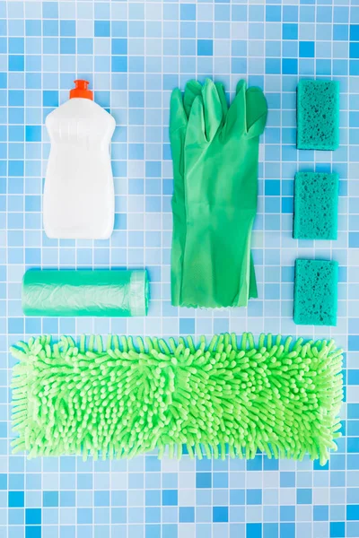 Colorful cleaning set for different surfaces in kitchen, bathroom and other rooms on kitchen mosaic surface background. Top view of cleaning service concept. — Stock Photo, Image