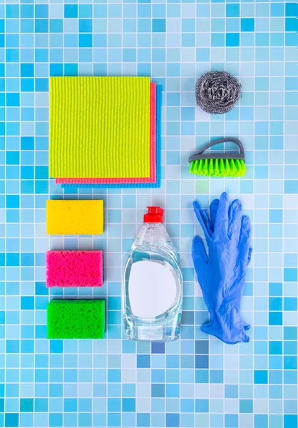 Colorful cleaning set for different surfaces in kitchen, bathroom and other rooms on kitchen mosaic surface background. Top view of cleaning service concept. — Stock Photo, Image