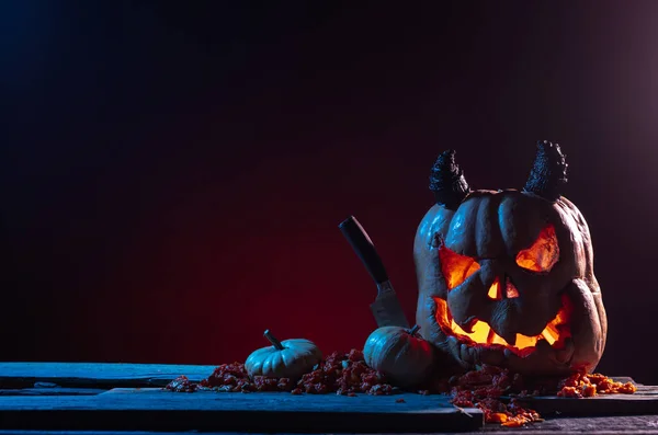 Scary Halloween pumpkins on wood in a spooky place at night. Poster concept — Stock Photo, Image