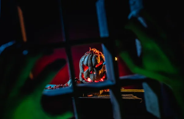 Scary Halloween pumpkins with hands in a spooky place at night. — Stock Photo, Image