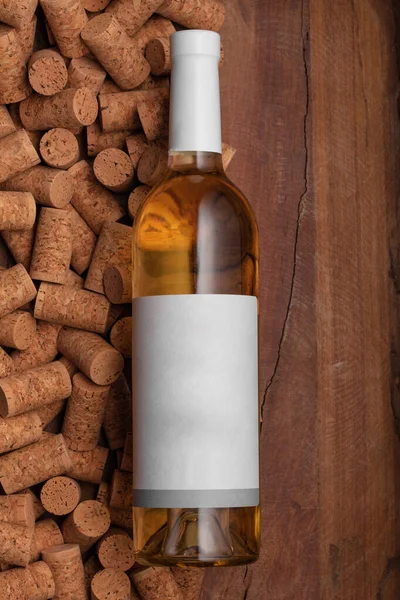 Πρότυπο λευκό γυάλινο μπουκάλι κρασί σε φελλούς και φόντο ξύλο. Αφίσα έννοια σχεδιασμό φωτογραφία γυρίσματα — Φωτογραφία Αρχείου