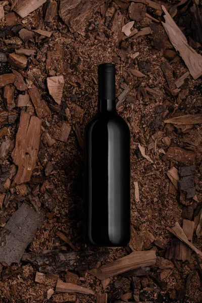 Black bottle with wine with corks on old wood chips background Poster concept design photo shooting — ストック写真