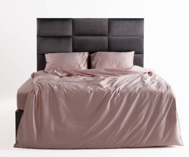 A chic bedroom showcases a sleek bed with a modern gray headboard. The soft pink bedding adds warmth, creating a cozy and inviting atmosphere in a minimalist setting.