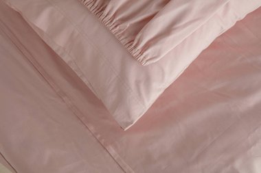 Yumuşak kıvrımlar ve kıvrımlarla yumuşatıcı bir görüntü oluşturan şeftali rengi kumaş zarif bir şekilde düzenlenmiştir. Malzeme öğleden sonra ışıklarını yakalıyor, sıcaklığını ve dokusunu arttırıyor..