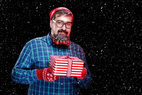 Man with a present box against black background