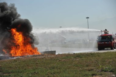 Almaty / Kazakistan - 09.05.2011: Havaalanında itfaiye eğitimi. Kurtarma ekibi yangının yerini belirleyip yangını söndürüyor..