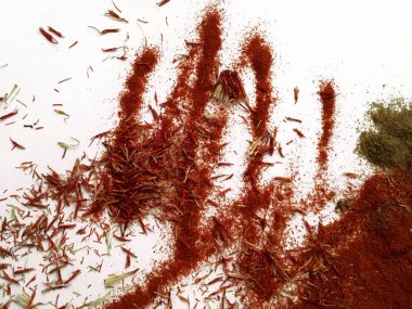 Doğu'nun sıcak boğucu nefes sıcak bir hatırlatma olarak beyaz bir arka plan üzerinde doymuş ateşli kırmızı, turuncu ve yeşil renklerin kurutulmuş baharatlı baharat ve otlar parçacıkların bir saçılma