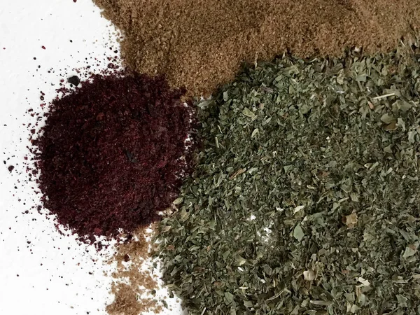 Doğu'nun sıcak boğucu nefes sıcak bir hatırlatma olarak beyaz bir arka plan üzerinde doymuş ateşli kırmızı, turuncu ve yeşil renklerin kurutulmuş baharatlı baharat ve otlar parçacıkların bir saçılma