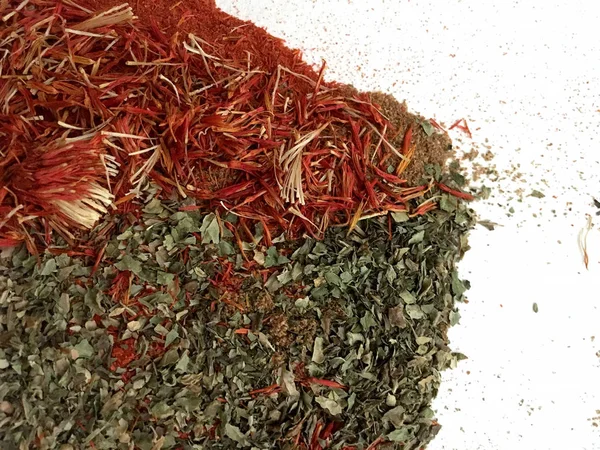 Doğu'nun sıcak boğucu nefes sıcak bir hatırlatma olarak beyaz bir arka plan üzerinde doymuş ateşli kırmızı, turuncu ve yeşil renklerin kurutulmuş baharatlı baharat ve otlar parçacıkların bir saçılma