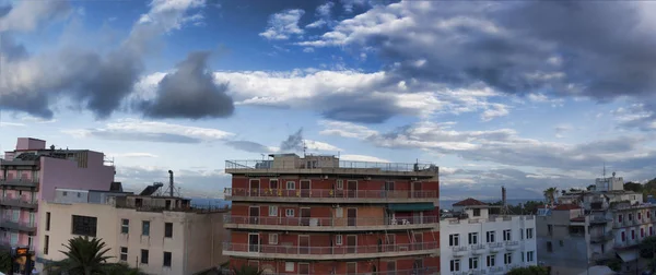 Old hotels by the sea, dramatic sky, panoramic view. Loutraki, Greece