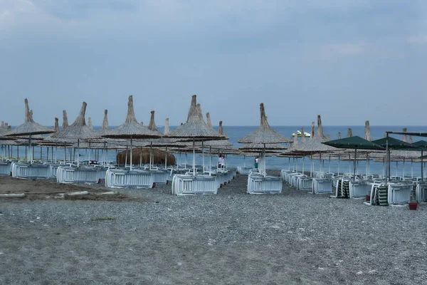 Beach in the evening with upturned deck chairs — Stock Photo, Image