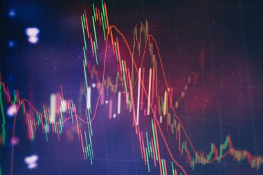 Borsa grafiği öndeki ekranda. Finans ve yatırım konsepti. Seçici odak.