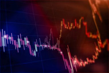 Borsa grafiği öndeki ekranda. Finans ve yatırım konsepti. Seçici odak