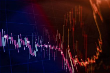 Borsa grafiği öndeki ekranda. Finans ve yatırım konsepti. Seçici odak