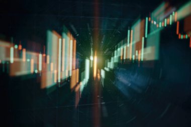 Borsa grafiği öndeki ekranda. Finans ve yatırım konsepti. Seçici odak.