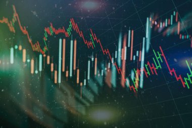 Borsa grafiği öndeki ekranda. Finans ve yatırım konsepti. Seçici odak.