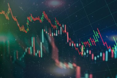 Borsa grafiği öndeki ekranda. Finans ve yatırım konsepti. Seçici odak.