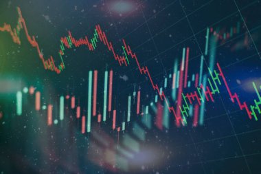 Borsa grafiği öndeki ekranda. Finans ve yatırım konsepti. Seçici odak.