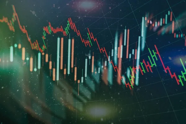 Borsa grafiği öndeki ekranda. Finans ve yatırım konsepti. Seçici odak.