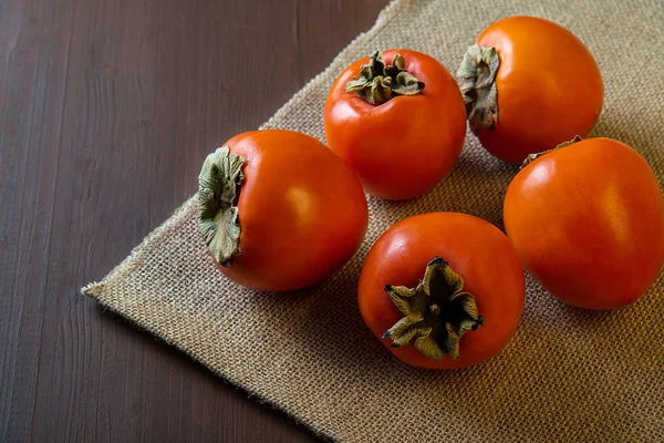 Persimmon Burlap Wooden Table — Stock Photo, Image