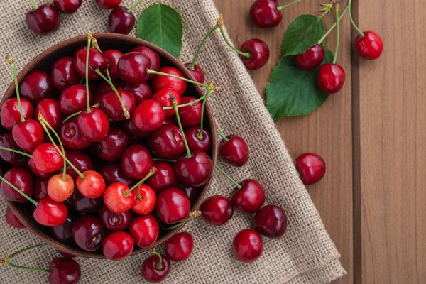 Cereza dulce fresca en un plato sobre una mesa de madera . —  Fotos de Stock