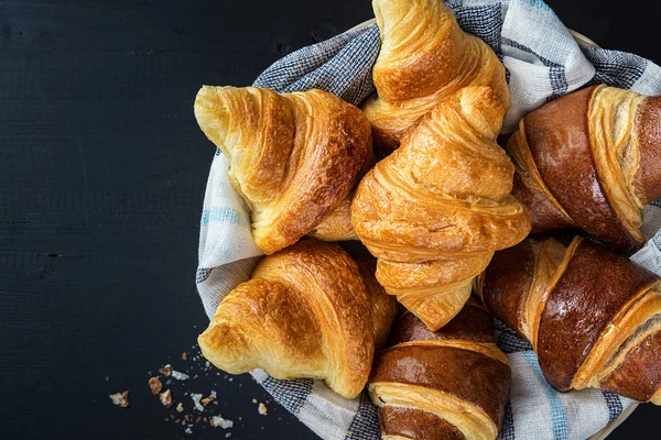 bite croissants with chocolate on a basket, french kitchen, breakfast