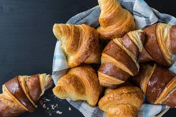 bite croissants with chocolate on a basket, french kitchen, breakfast