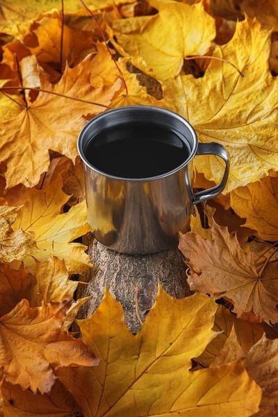 Mug of tea, autumn leaves, beautiful autumn composition with teacup. autumn forest, tea time. Concept of fall season.