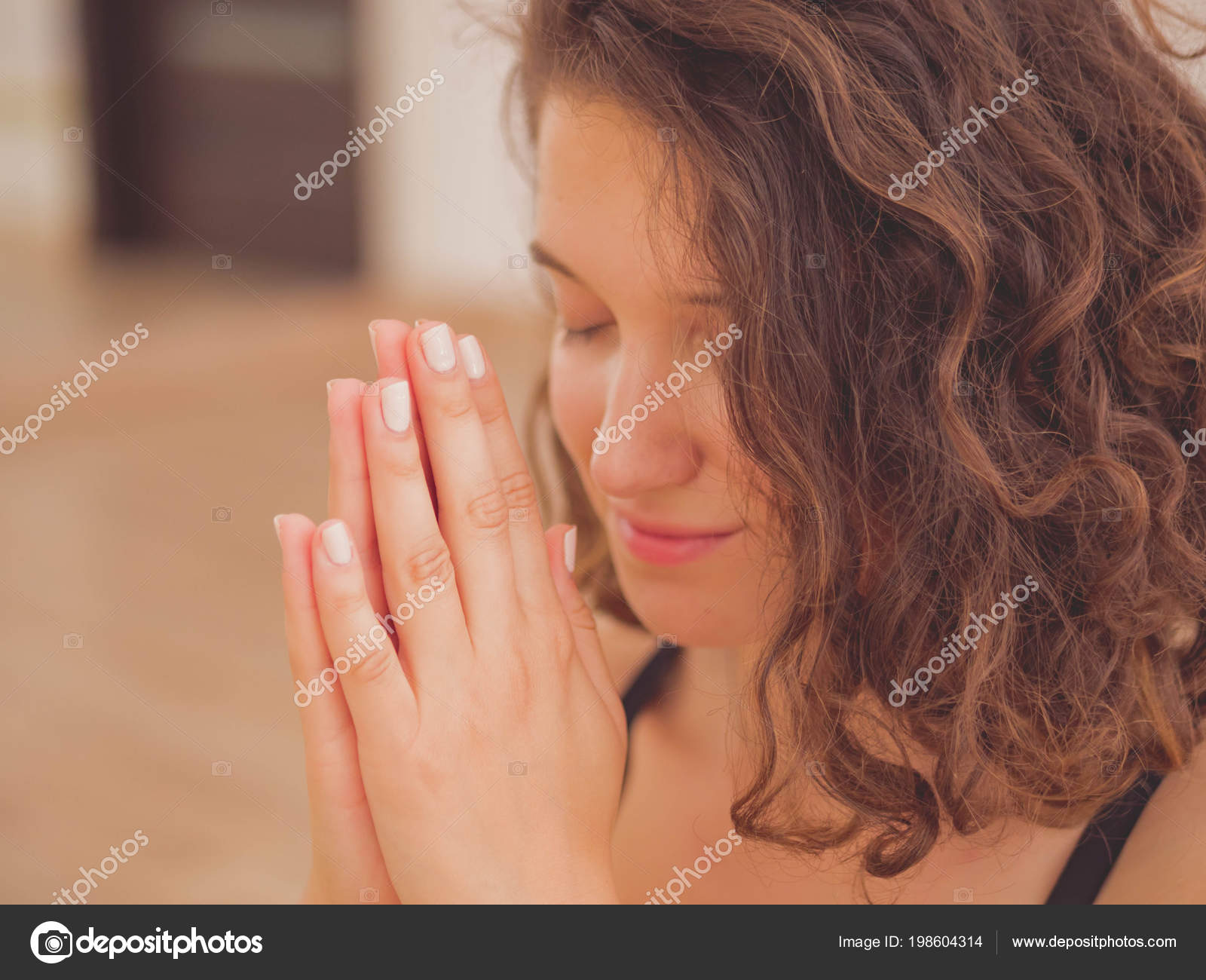 Young Beautiful Woman With Short Curly Hair Meditating In Light
