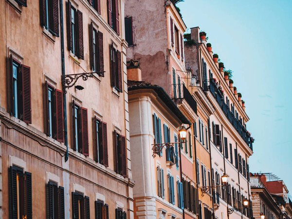 Beautiful facade of apartment building in Rome, Italy. Windows with shutters.