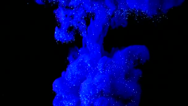 Bleu profond avec de l'encre pailletée en noir sous-marin. Peinture brillante indigo couleur réagissant dans l'eau créant des formations de nuages abstraites. Peut être utilisé comme transitions, ajouté aux projets. Mouvement lent . — Video