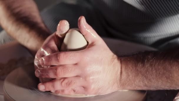 Artysta prowadzi ręce, które delikatnie tworzenia poprawnie w kształcie ręcznie z gliny. Dokonywanie, nauczyciel przedstawia podstawy ceramiki w studio sztuki tradycyjnej ceramiki. Czarno-białe tonned. — Wideo stockowe