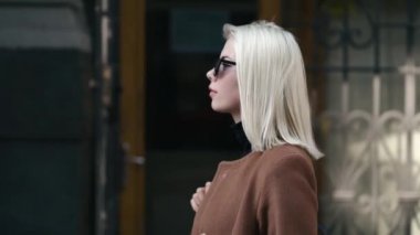 Sonbahar şehirde genç çekici sarışın kadın portresi. Kız şık bir görünüm, güneş gözlüğü ve burun piercing var. Bayan yalnız street yürüyüş. Moda ve güzellik kavramı