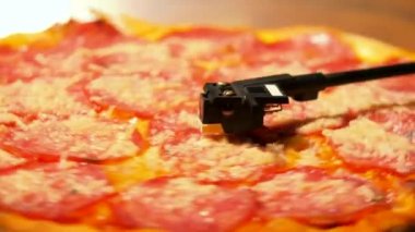 Parti lezzetli abur cubur ile. Salam sosis ve peynir pikap vinil oyuncu vinil kayıt olarak iplik İtalyan pizza.
