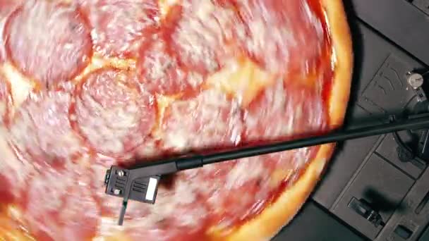 Pizza pepperoni spinning on turntable vinyl player as record. Concept of party with delicious fast food. Italian traditional cuisine with salami sausage and cheese. Top view. — Stock Video