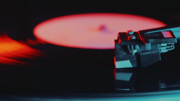Retro-styled spinning record vinyl player. 4k. Close up. Rotating vintage phonograph close up. Beautiful colorful movie. Neon led light. — Stock Video