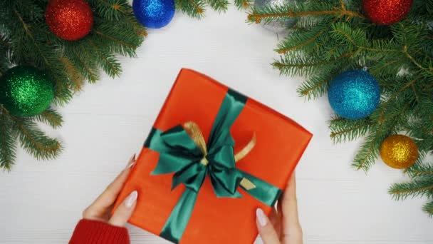 Female Hands Warm Red Sweater Giving Present Red Paper Corrects — Stock Video