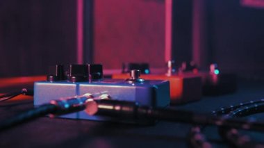 Guitar pedals and footswitch inside recording room. Close up of guitar pedals and musicians foot tapping on it for different sounds. Macro view. 4k.