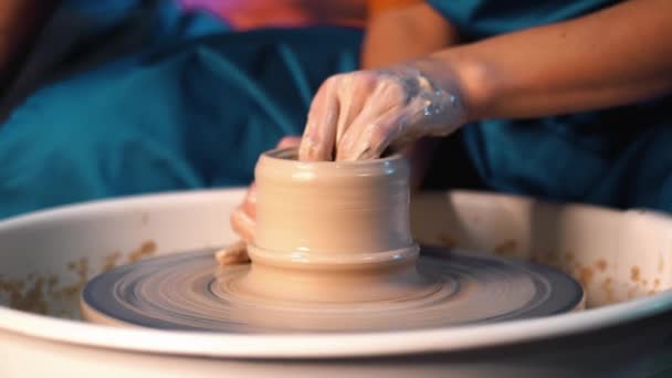 Poterie traditionnelle, homme enseignant montre les bases de la poterie en atelier d'art. Artiste opère les mains, qui créent doucement la cruche correctement façonnée à la main à partir d'argile. 4k — Video
