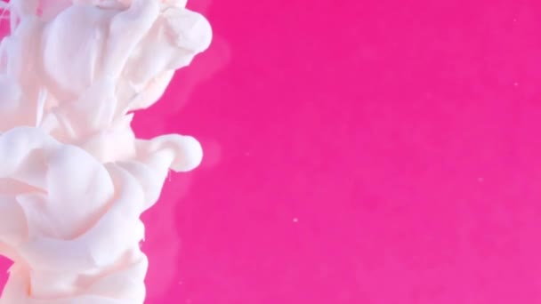 Ink in water. White paint on pink reacting in water creating abstract cloud formations.Can be used as transitions,added to modern projects,art backgrounds, anything with creative twist. — Stock Video