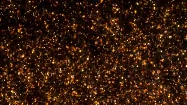 Movimento de ouro fundo em preto com estrelas. Partículas espumantes de cobre Bokeh movem-se caoticamente sob a água. Pode ser usado como transições em projetos . — Vídeo de Stock