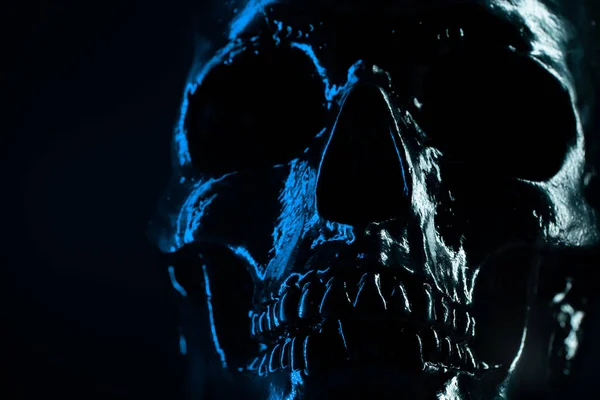 Human blue skull on dark background. Concept of fear, death and horror, Halloween celebration. Spooky and sinister. — Stock Photo, Image