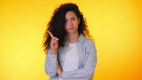 Mulher desaprovando sem sinal de mão fazer gesto dedo negação. Negando, rejeitando, discordando, retrato de bela estudante ou mulher de negócios em fundo amarelo . — Vídeo de Stock